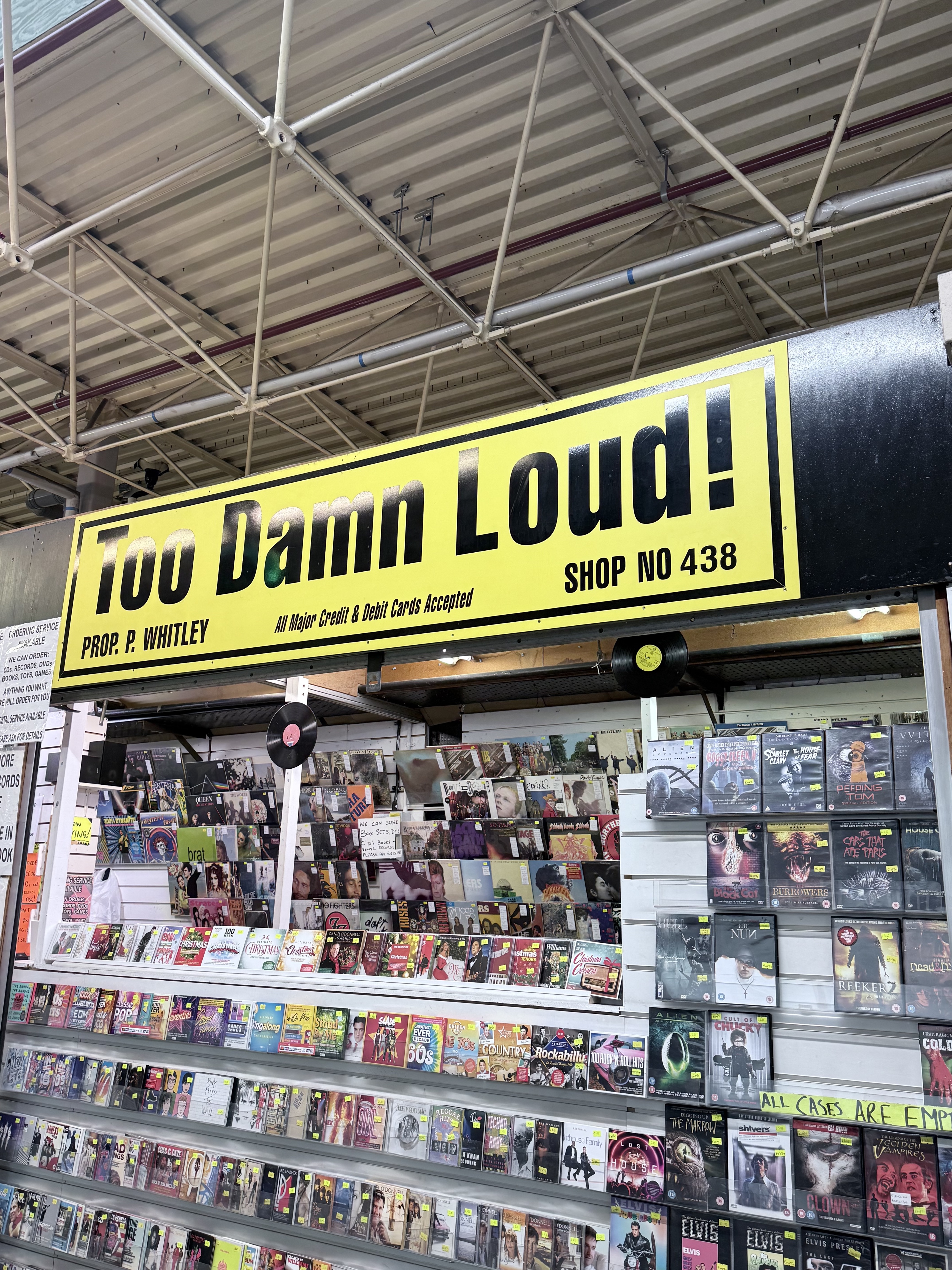 Market stall with records and signage
